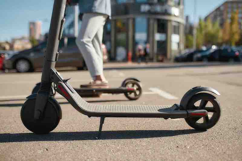 Ecological means of transportation. Rental electric scooters standing on the street